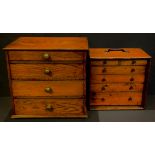 A set of early to mid-20th century oak engineer's drawers; a graduated set of four oak collector's
