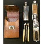 A leather cased Edwardian/early 20th century grooming/curling set