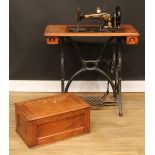 A late 19th century Singer sewing machine, treadle base, 97.5cm high, 81.5cm wide, 41.5cm deep