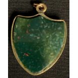 A Victorian shield shaped fob locket, set with bloodstone