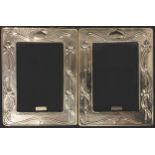 A pair of contemporary Art Nouveau style hallmarked silver photograph frames, wooden easel backs,