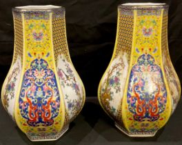 A pair of Chinese export ware printed polychrome hexagonal baluster vases, decorated with