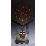 An Arts & Crafts oak wall clock, hexagonal dial applied with brass Arabic numerals, beaded