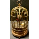 A reproduction novelty automaton clock, as a bird in a cage, 15cm high