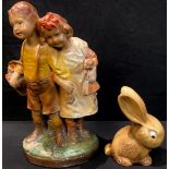 A 1930's painted chalk model of two children, 39cm high; a rabbit model (2)