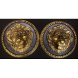 A pair of reconstituted stone wall plaques as lion mask bosses, rope twist border, 30cm diameter
