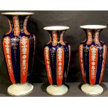 A garniture of three 19th century fluted vases, the largest 32cm high