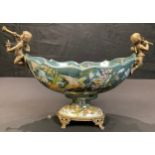 A "French" boat shaped table centre, with gilt cherub musicians, approx 30cm wide over handles
