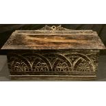An 18th century carved oak candle box, hinged cover, later replacement base, 33cm wide