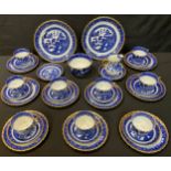 An Aynsley Willow pattern tea set comprising nine teacups, eleven saucers, nine tea plates, milk jug