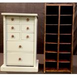 A set of oak pigeon holes, 57cm wide; a painted collector's/spice cabinet, 48cm high (2)