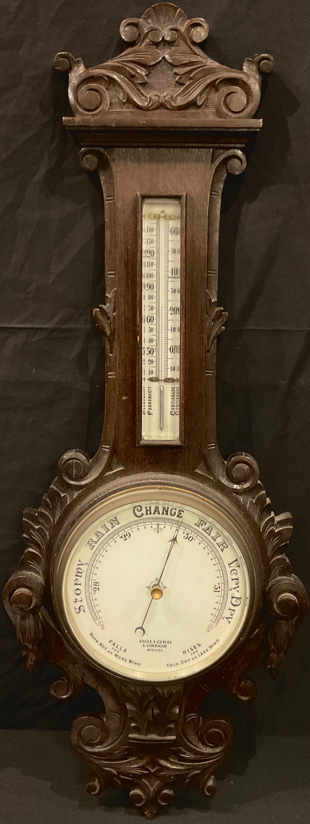 A late Victorian oak aneroid wheel barometer, Dolland, London