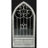 Interior Decoration - a large Gothic arch topped wall mirror, the plate set behind metal scrollwork,