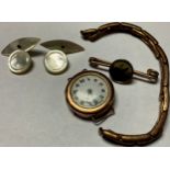A lady's 9ct gold wristwatch, London 1928; a horseracing brooch; a pair of mother-of-pearl cufflinks