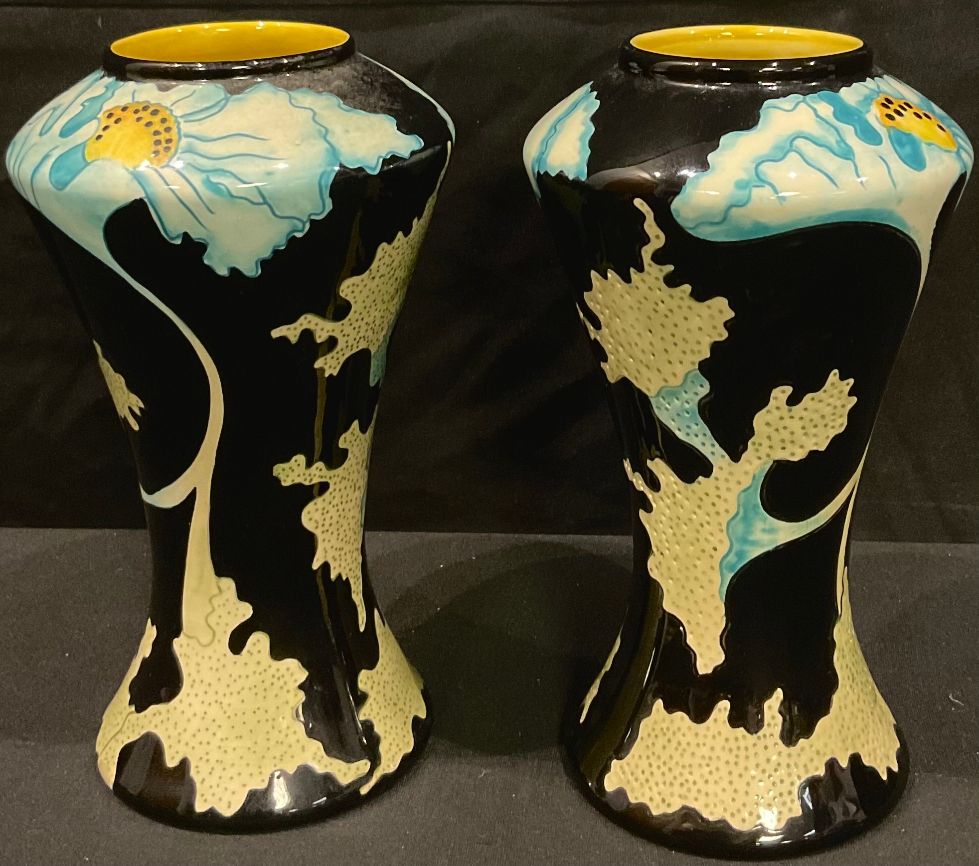 A pair of Black Ryden Papaver pattern waisted cylindrical vases, incised with flowing foliate stems,