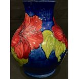 A Moorcroft Hibiscus pattern baluster vase, 24cm, faults