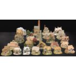 A collection of Lilliput Lane cottages including The Greengrocers, The Christmas Present,