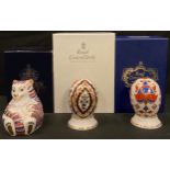 A pair of Royal Crown Derby Eggs of the World on stands, India and England pattern, each boxed,