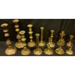 A pair of Victorian brass spiral column candlesticks, 17cm high; other brass candlesticks, early