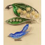 A silver and enamel lily of the valley brooch, Birmingham 1918; another, marked Sterling; an