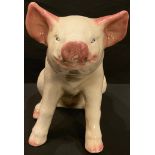 A large pottery model of a pig, possibly butcher's shop display, 34cm high