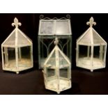 A pair of Victorian style hexagonal terrariums, 33cm high; another, smaller; a square terrarium,