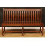 An oak lath back bench or hall settle, 99.5cm high, 155.5cm wide, the seat 36cm deep