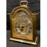 A Swiza brass bracket style alarm mantel clock, arched case, engraved dial with Tempus Fugit