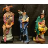 A Royal Doulton figure, The Mask Seller HN2103; two others, The Jester HN2016; The Wizard HN2877 (3)