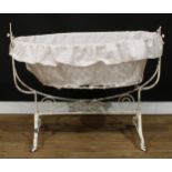 An early to mid-20th century French rocking cradle or crib, 95.5cm high, 115cm wide, 53.5cm deep