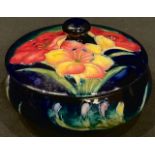 A Moorcroft Orchid pattern circular powder bowl and cover, 12.5cm diameter, impressed marks