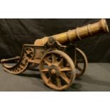 A cast iron and brass desk cannon, 43cm wide, 21cm high