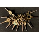 A collection of sixteen pocket watch keys