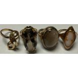 A 9ct gold ring set with an oval polished smokey quartz cabochon, size L, 8g; another 9ct gold