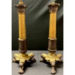 A pair of early 19th century Empire gilt bronze candlesticks, each as a Corinthian column
