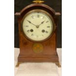 A late 19th/early 20th century mahogany inlaid mantel clock, arched case with brass carry handle,