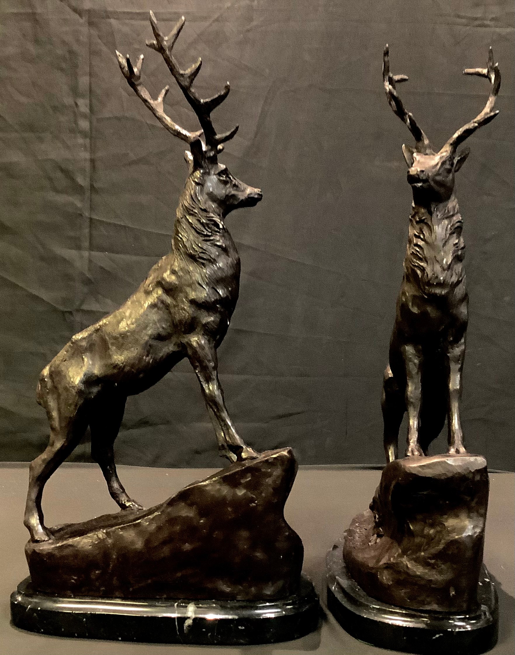 A pair of bronzed stags, after J Moigniez, each stood upon a rocky outcrop, 43cm high (2)