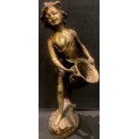 A bronzed metal sculpture of a girl with basket, 43cm high