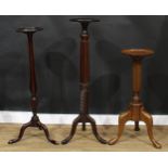 A 19th century style mahogany tripod statuary pedestal or torchère, 121.5cm high; two others,