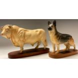 A Beswick Connoisseur model, Charolais Bull, oval mahogany stand; another Alsatian (2)