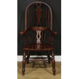 A Windsor elbow chair, hoop back, shaped and pierced splat, saddle seat, turned legs, double H-
