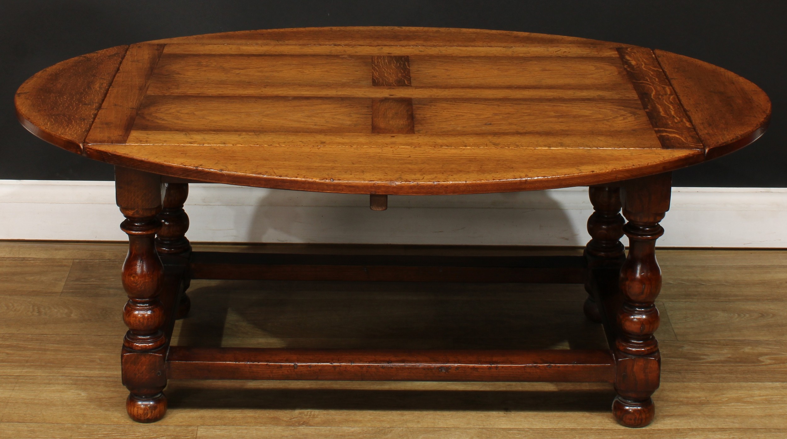 An oak drop-leaf coffee table, by Titchmarsh & Goodwin, badged, 48cm high, 96cm opening to 121cm