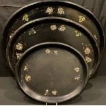 A set of three Victorian graduated papier-mâché oval trays, mother-of-pearl inlaid, the largest 76cm