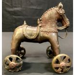 A cast metal Persian horse on wheels, after the antique, approx 15cm long, 18cm high, 20th century