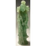 A Chinese jadite figure, of Guan Yin, standing, holding a lotus, 25.5cm high