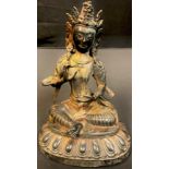 A bronzed metal figure as a seated goddess, possibly Tibetan, 20cm high, 20th century