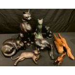 A bronzed model of a reclining cat; other assorted cat models, the tallest 43cm; an Austin