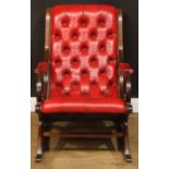 A George/William IV style library rocking chair, stuffed-over deep-button upholstery with studded