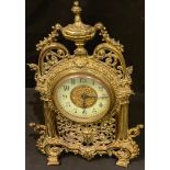 An early 20th century brass Rococo style strutt clock, 34cm high