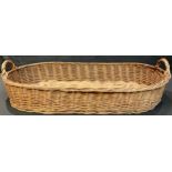 A vintage wicker baguette basket, 78cm wide